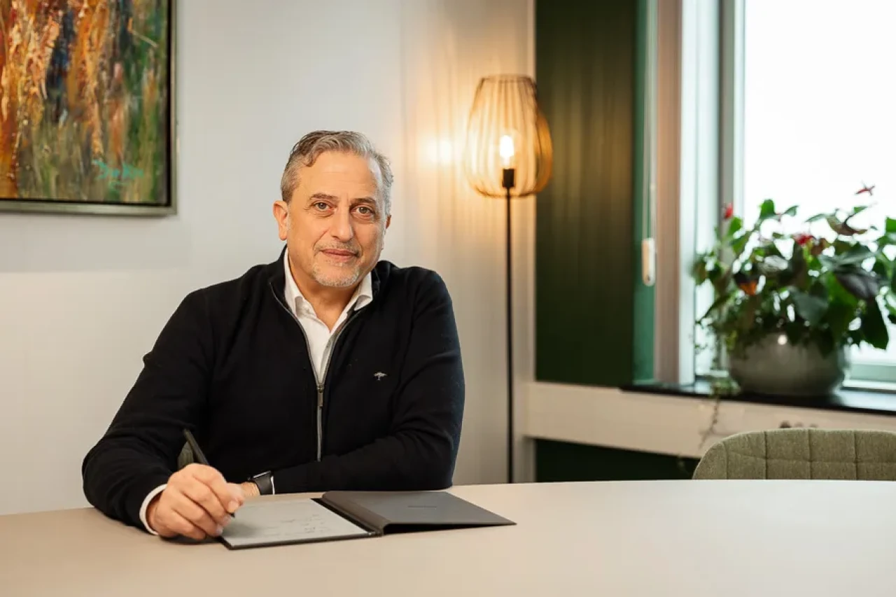 CC7 Europe's CEO sitting at his desk with a pen in his hand. CC7 Europe's CEO sitting at his desk with a pen in his hand.