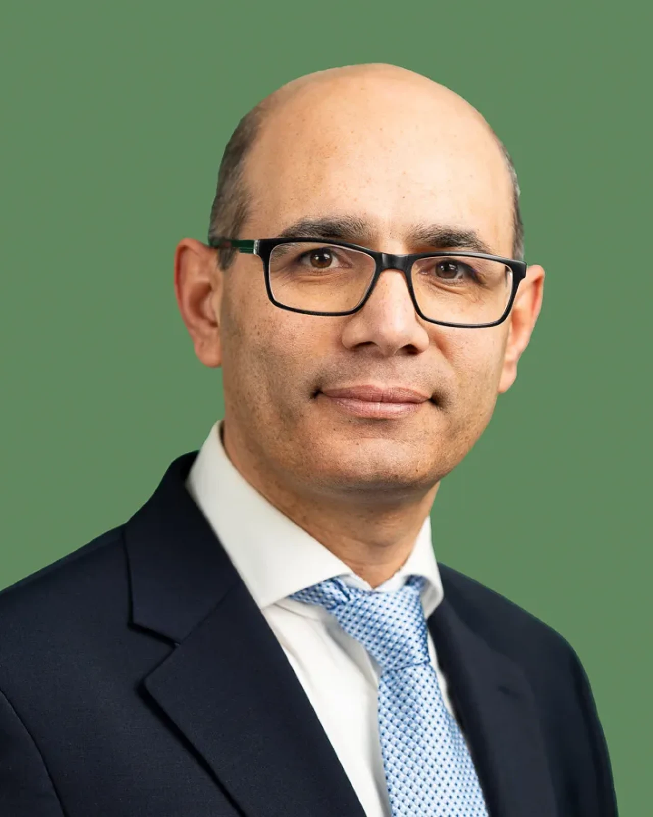 Smart man with glasses looking at camera with green background. Smart man with glasses looking at camera with green background.