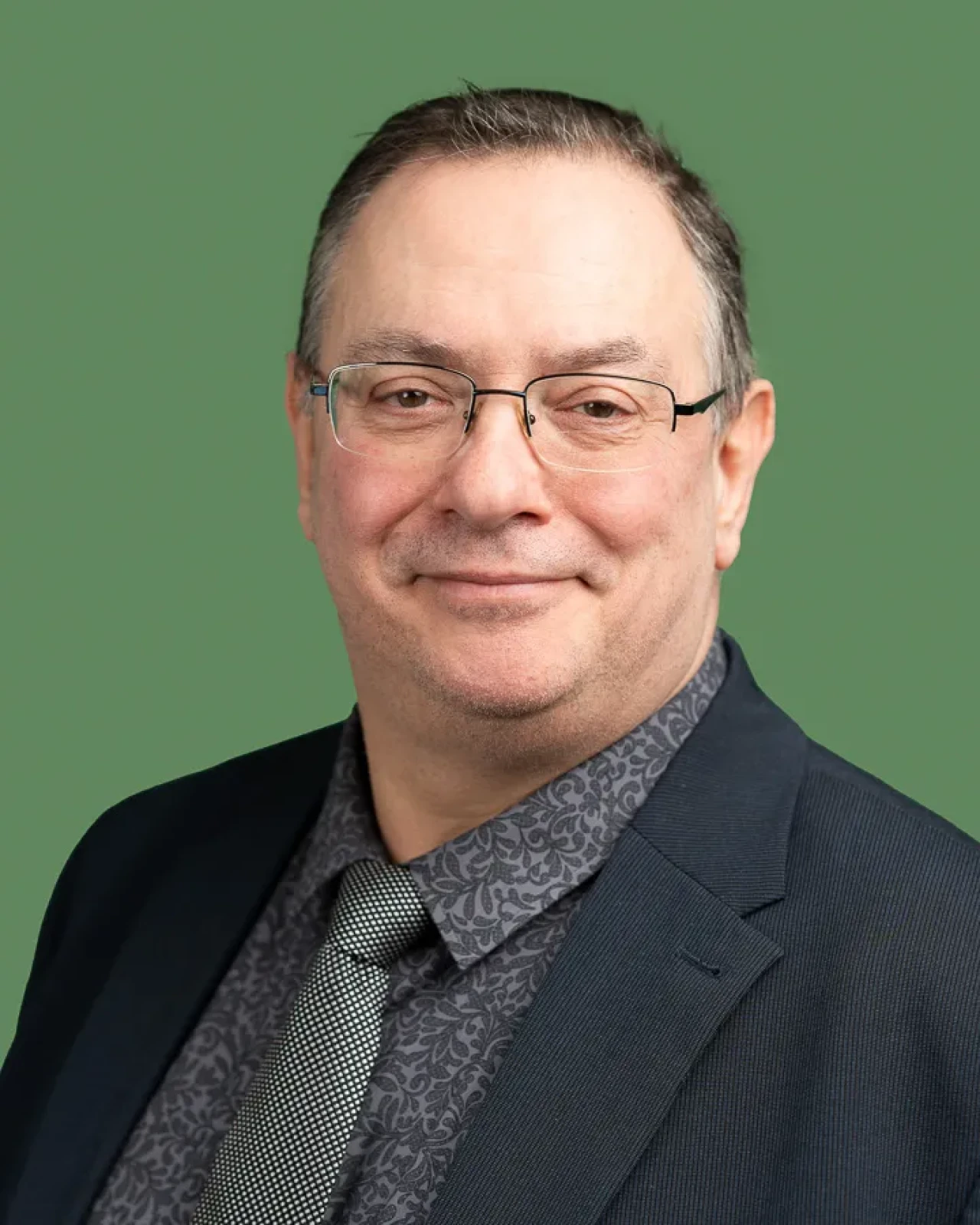 Smart man in suit looking at camera on a green background. Smart man in suit looking at camera on a green background.